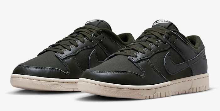 Side view of green and white Nike Dunk sneakers.